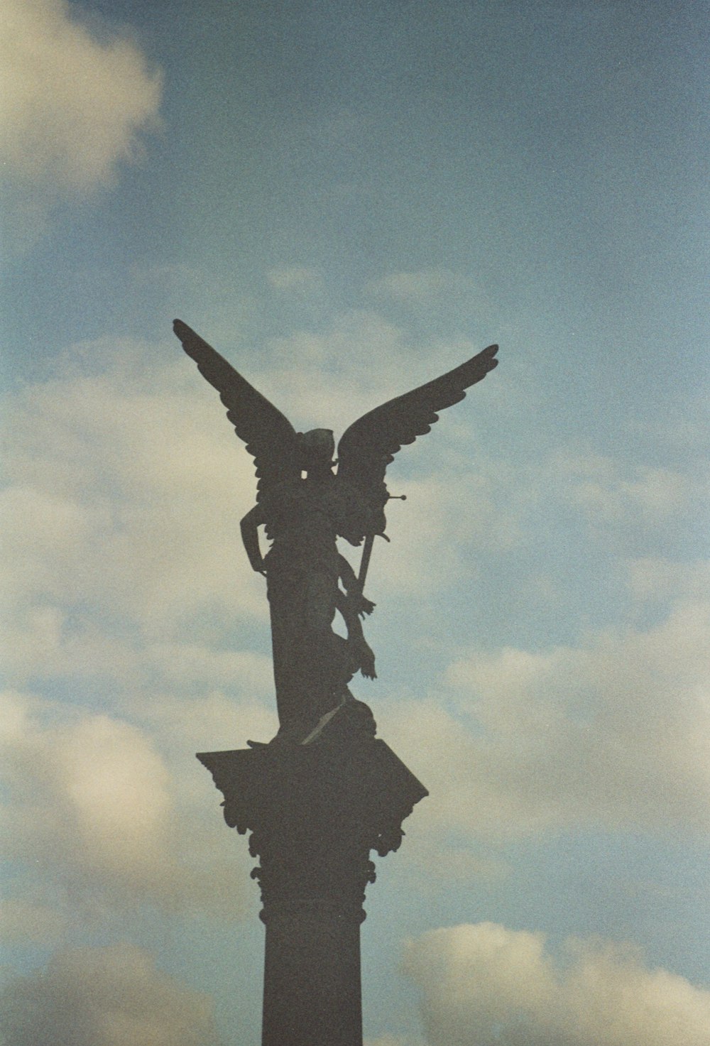 a statue of a person holding a cross