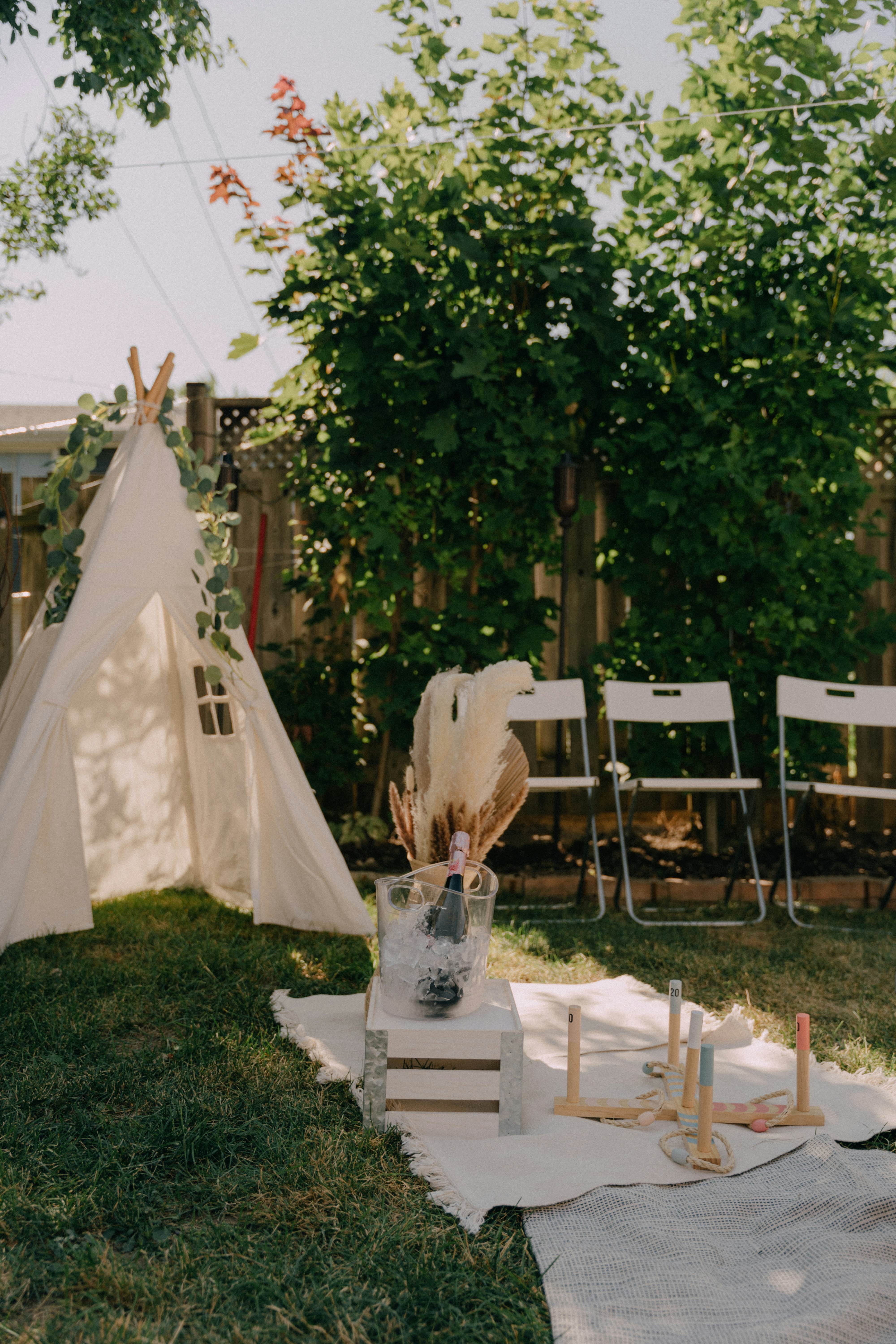 a white tent with a white table and chairs in front of it