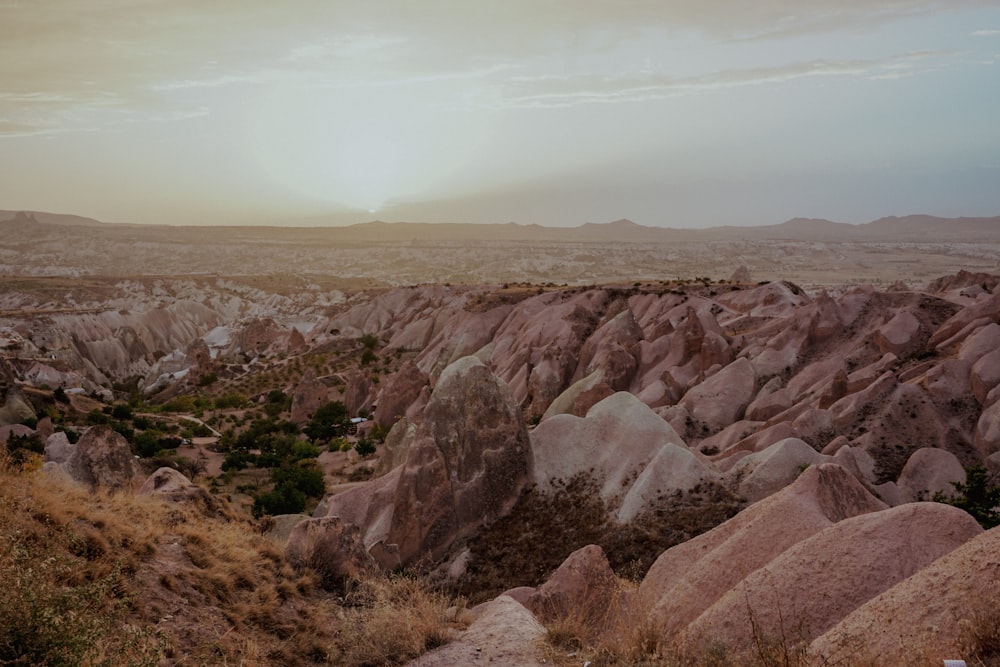 a rocky landscape with a valley in the background