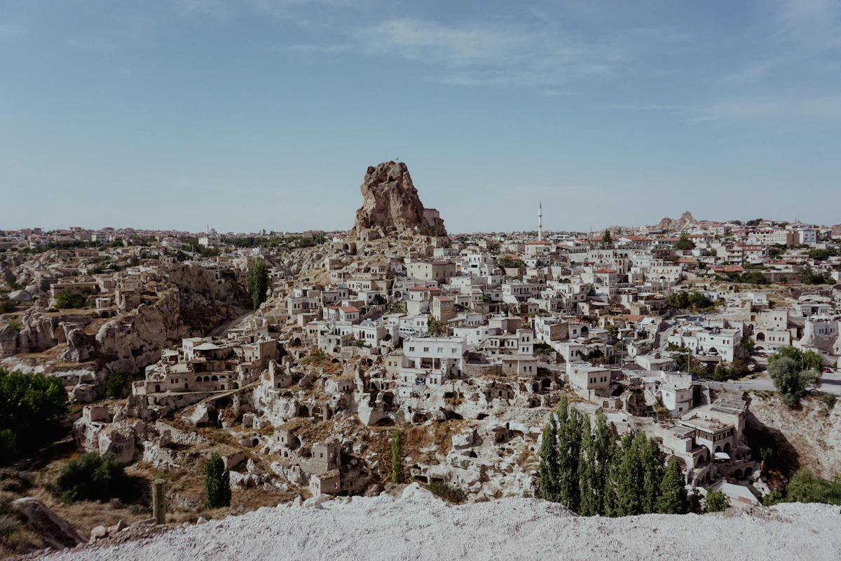 A rock castle rising above a village of pale stone houses