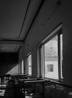 A serene landscape featuring an empty art studio with natural light streaming through large windows.