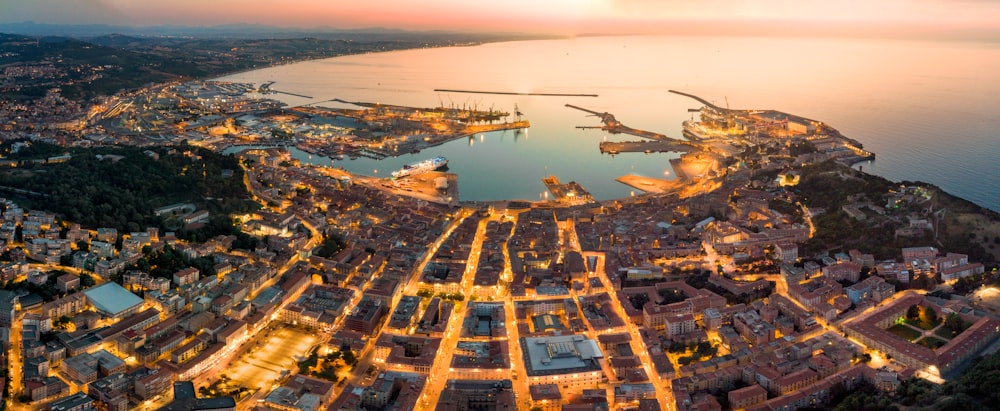 a city with a body of water and a helicopter flying over it