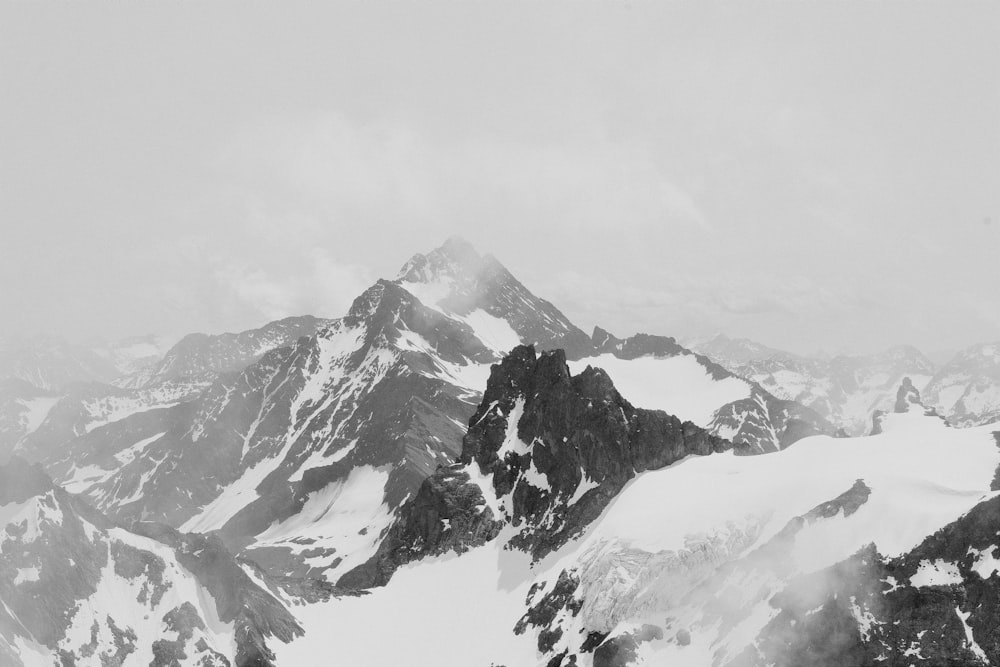 a snowy mountain with clouds