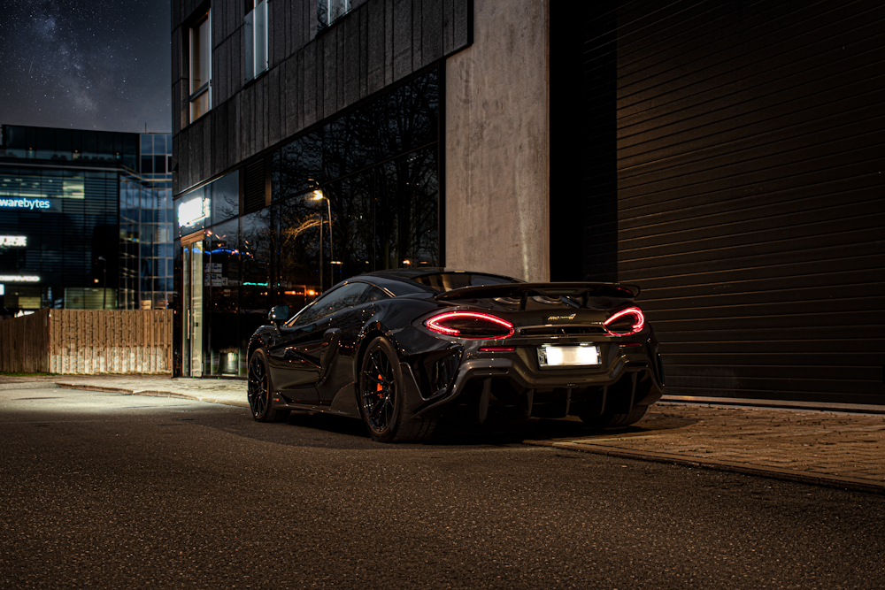 a black sports car parked on the side of a street