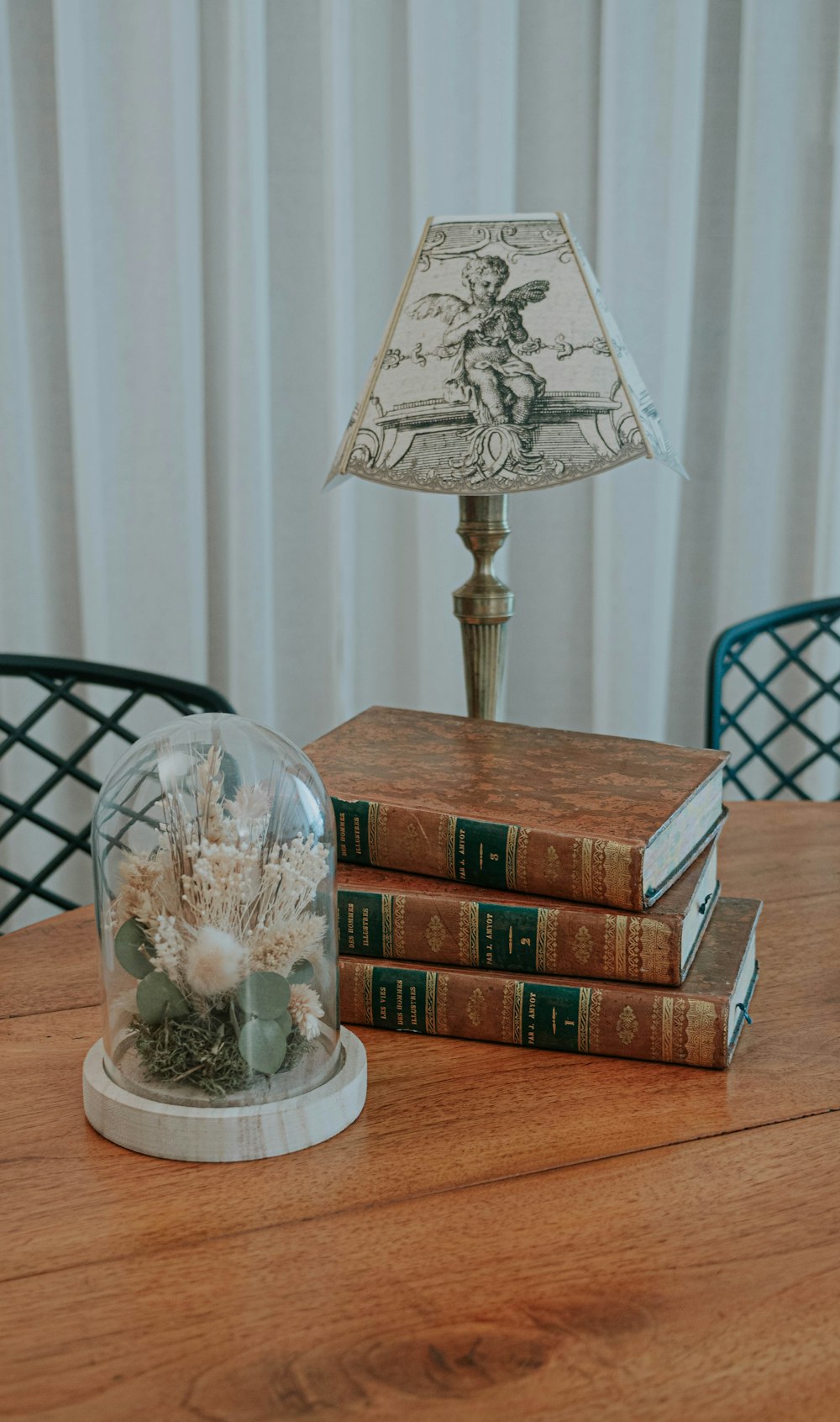 a vase and some books on a table