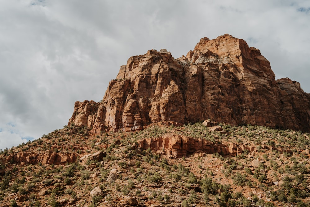 a rocky mountain with a valley below