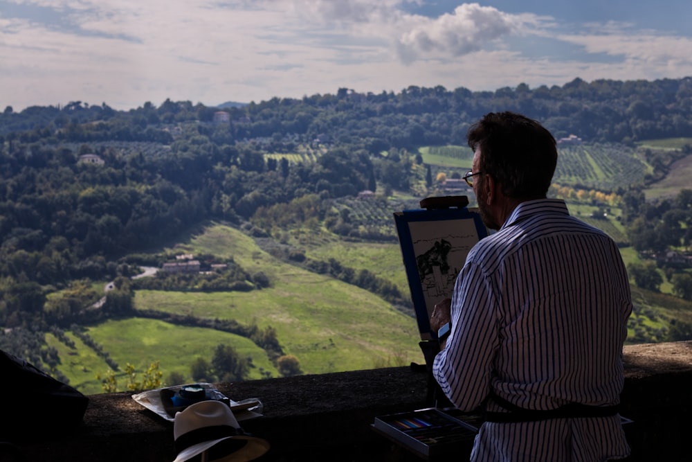 a man sitting at a table looking at a city