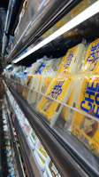 Neatly packaged ghee tubs stacked with a backdrop of fresh dairy ingredients.