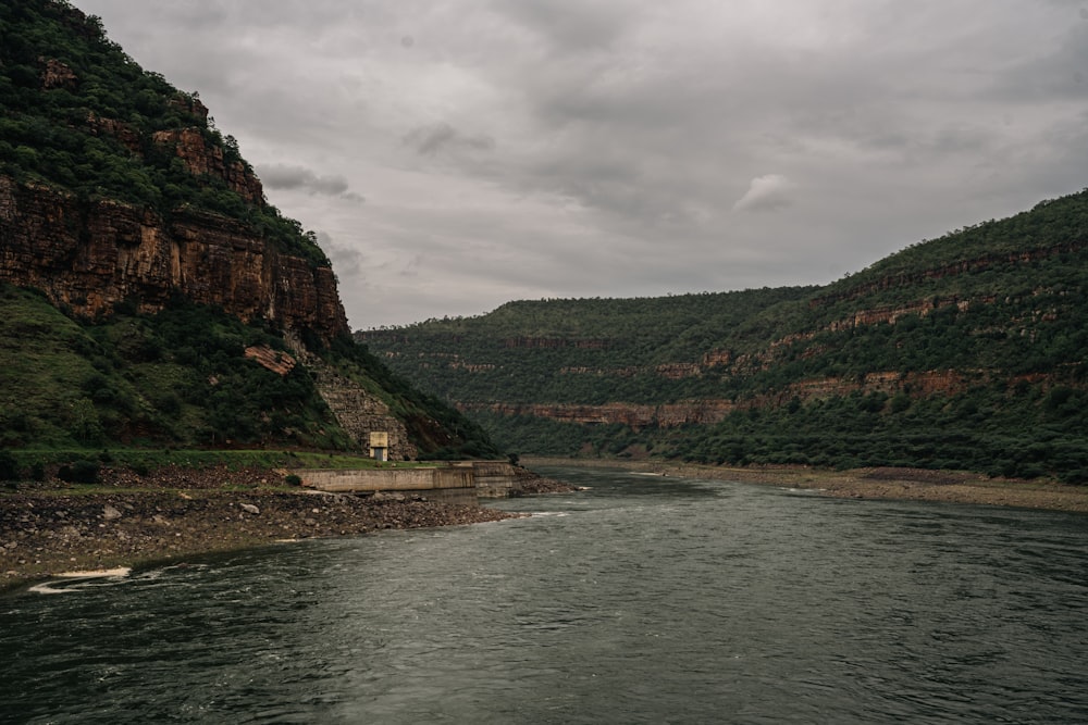 a body of water with hills in the back