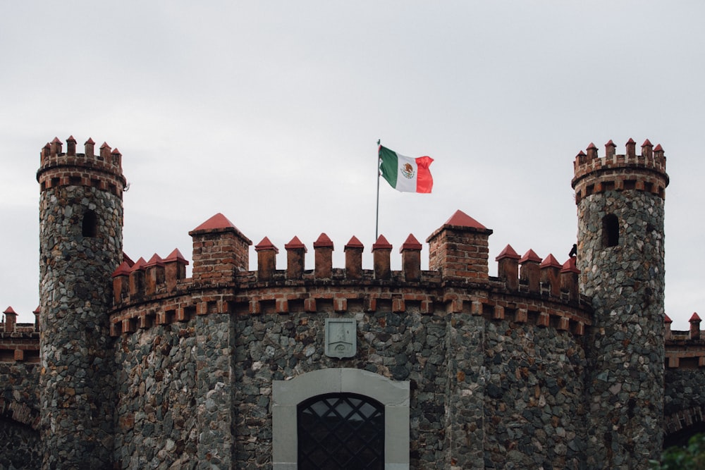 a stone castle with a flag on top