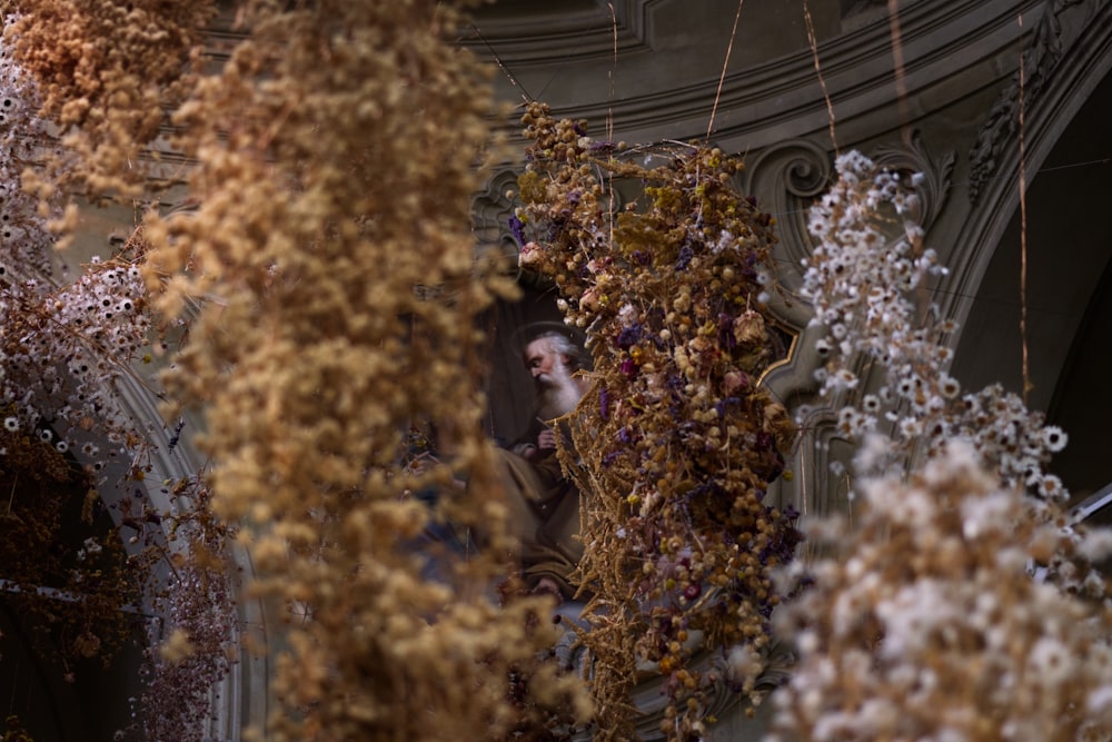 a person standing in a room with many trees with flowers