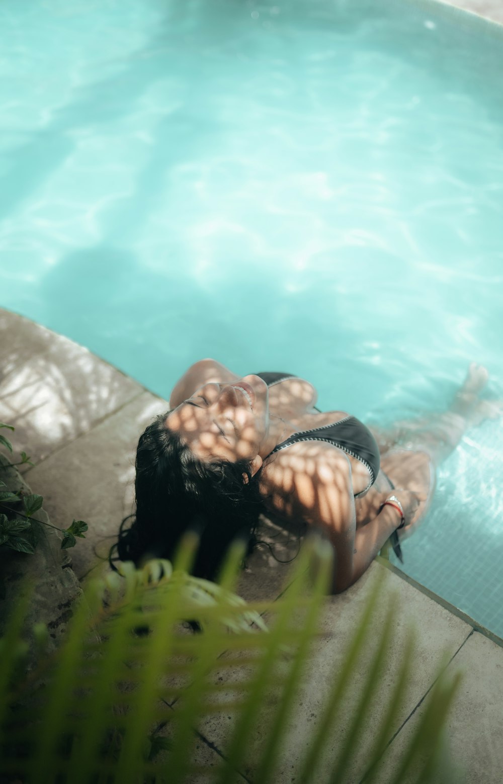 a person lying in a pool