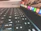 Close-up of hands packing a keyboard for delivery with NZ shipping labels.