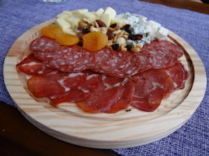 A beautifully arranged platter of Iberian delicacies including ham, cheese, and chorizo.