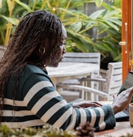 a person standing in front of a laptop computer talking on a cell phone