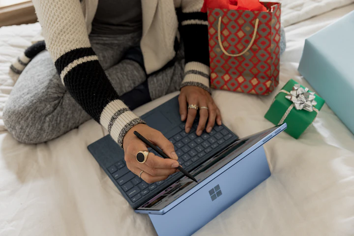 Person using a laptop to create an online wishlist