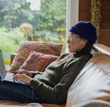 a person sitting at a table using a laptop