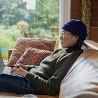 a person sitting at a table using a laptop