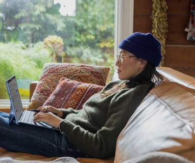 a person sitting at a table using a laptop