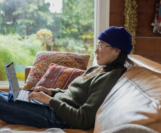 a person sitting at a table using a laptop