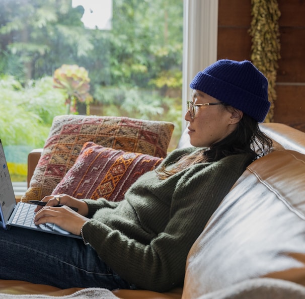 a person sitting at a table using a laptop