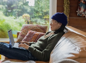 a person sitting at a table using a laptop