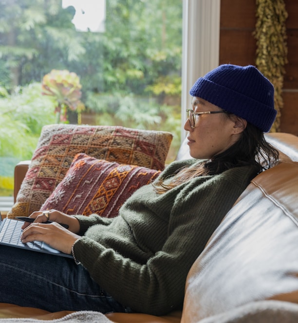 a person sitting at a table using a laptop