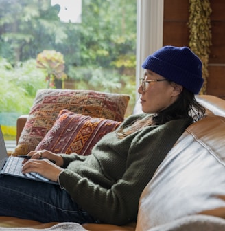 a person sitting at a table using a laptop