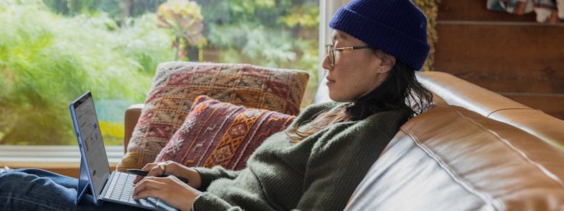 a person sitting at a table using a laptop