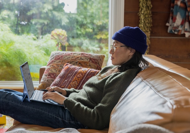 a person sitting at a table using a laptop