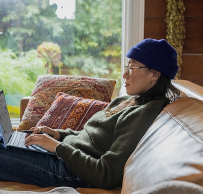 a person sitting at a table using a laptop