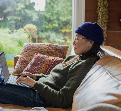 a person sitting at a table using a laptop