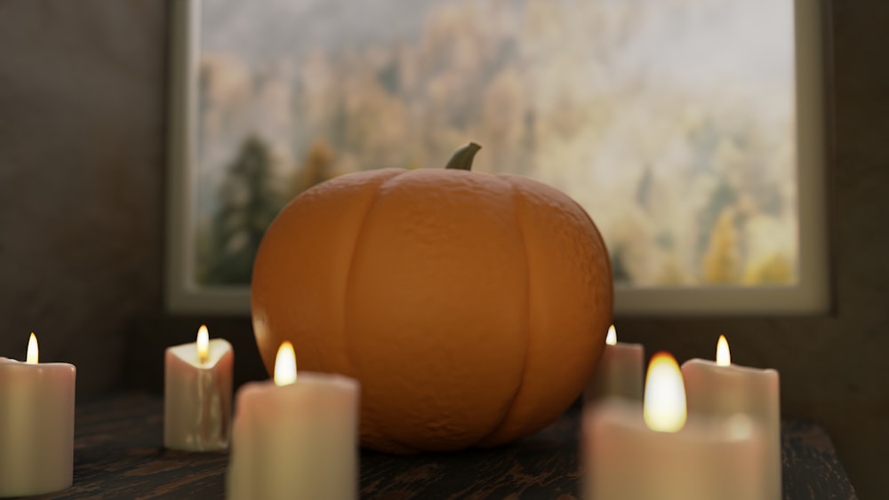 a pumpkin with candles in front of it