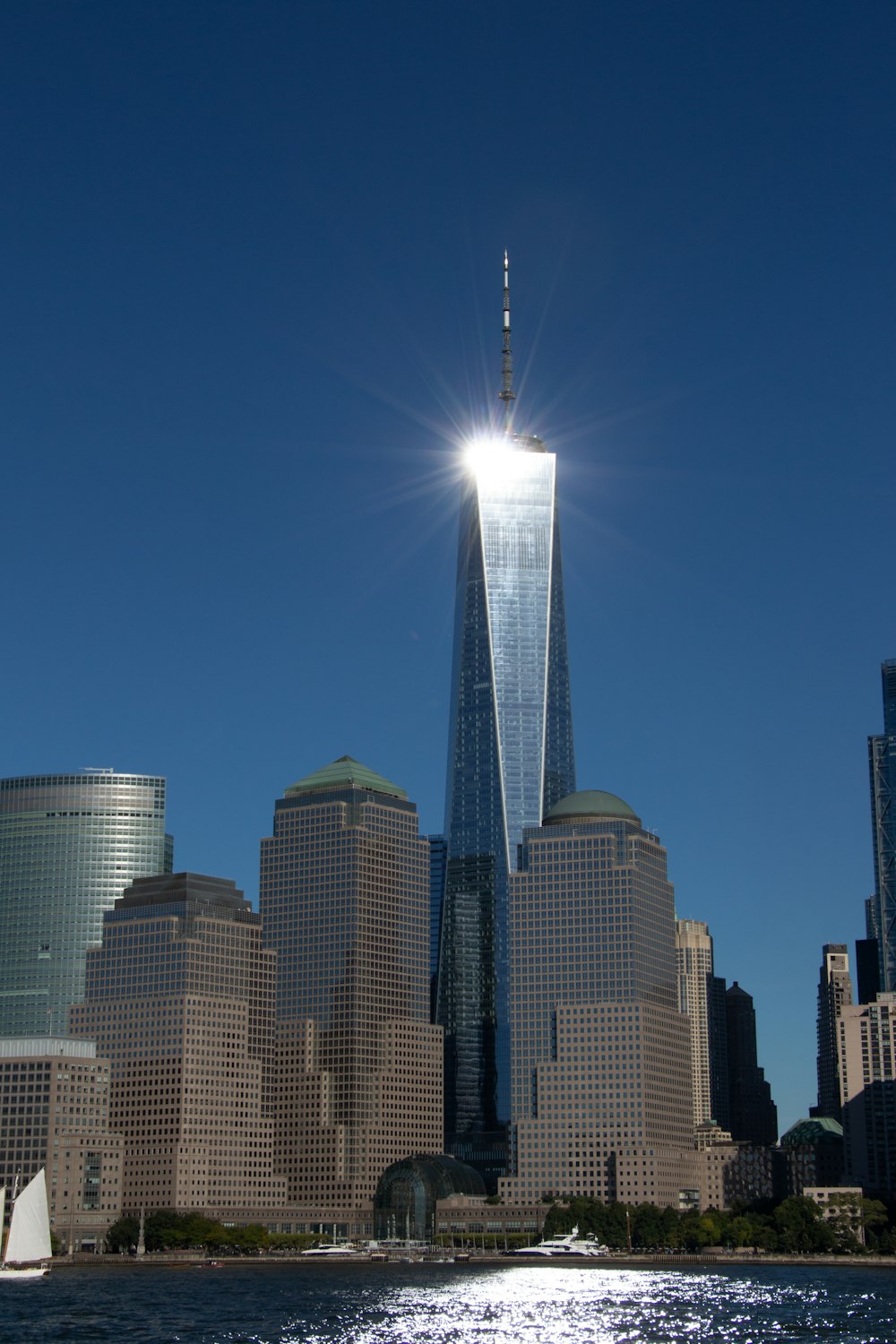 a city skyline with a body of water in the foreground