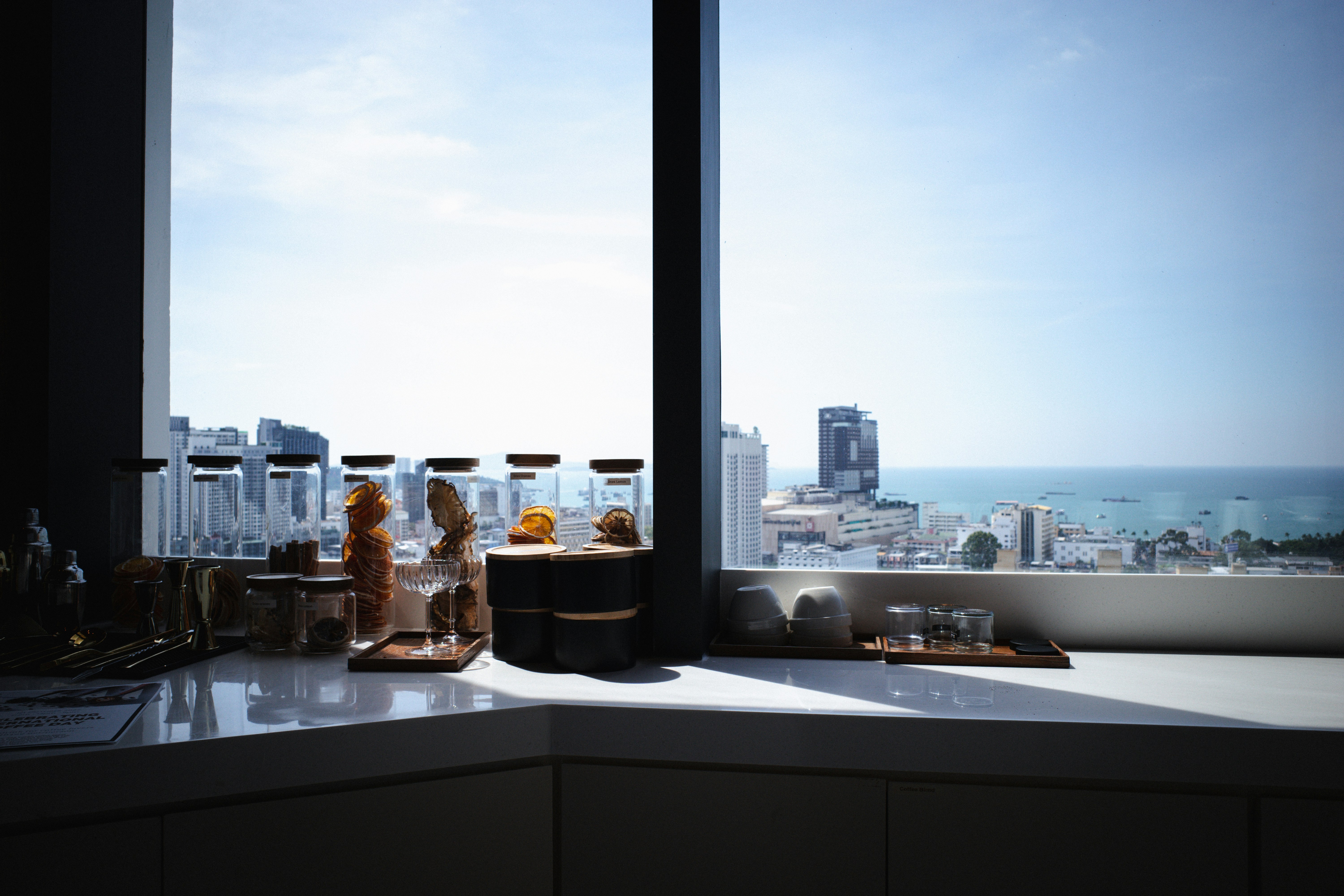 A person enjoying a cup of coffee on a stylishly decorated apartment balcony overlooking the Chicago skyline. - apartments for rent in chicago with balconies