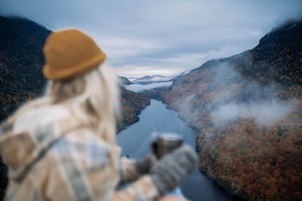 a person in a helmet looking at a mountain