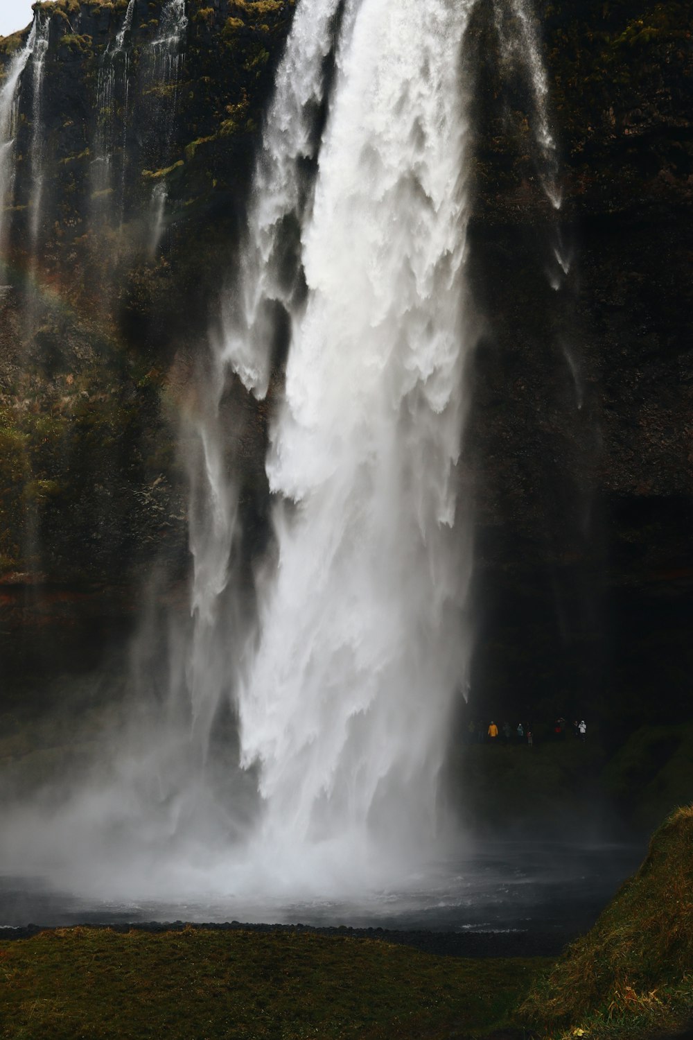 a waterfall with a rainbow