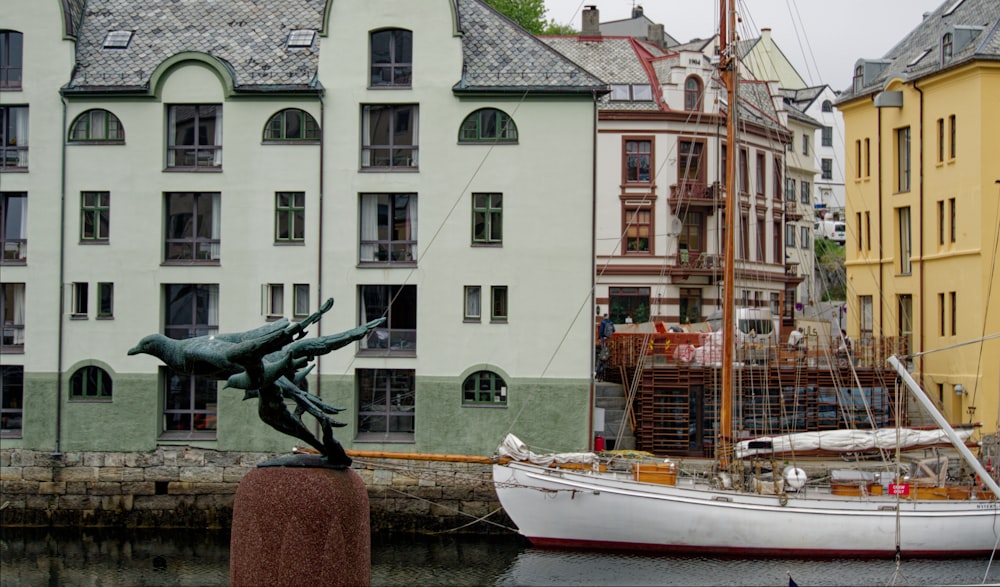 a boat in the water by buildings