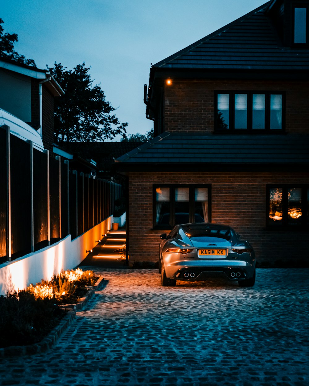 A car parked in front of a house at night photo – Free Uk Image on Unsplash