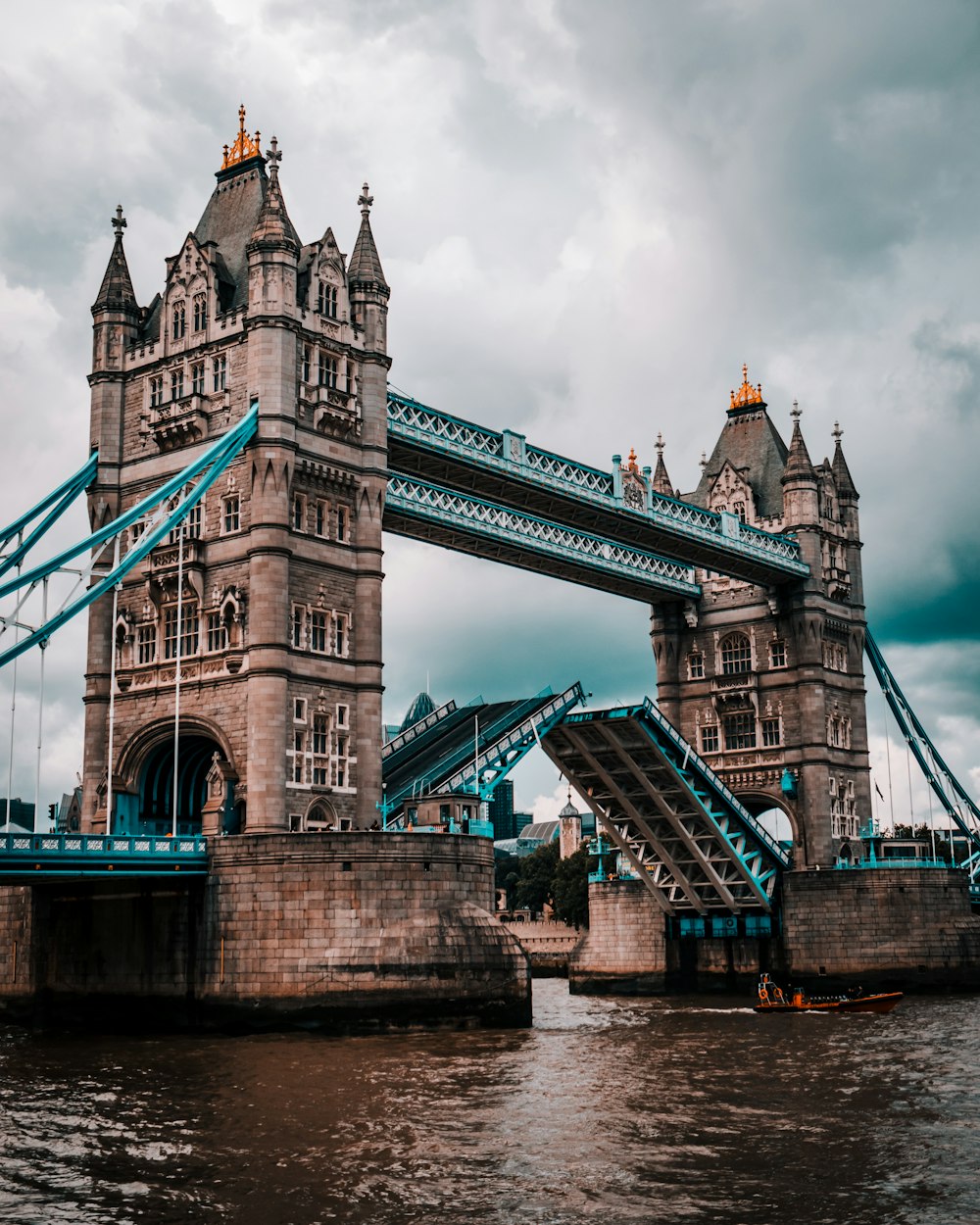 a bridge with towers and a boat