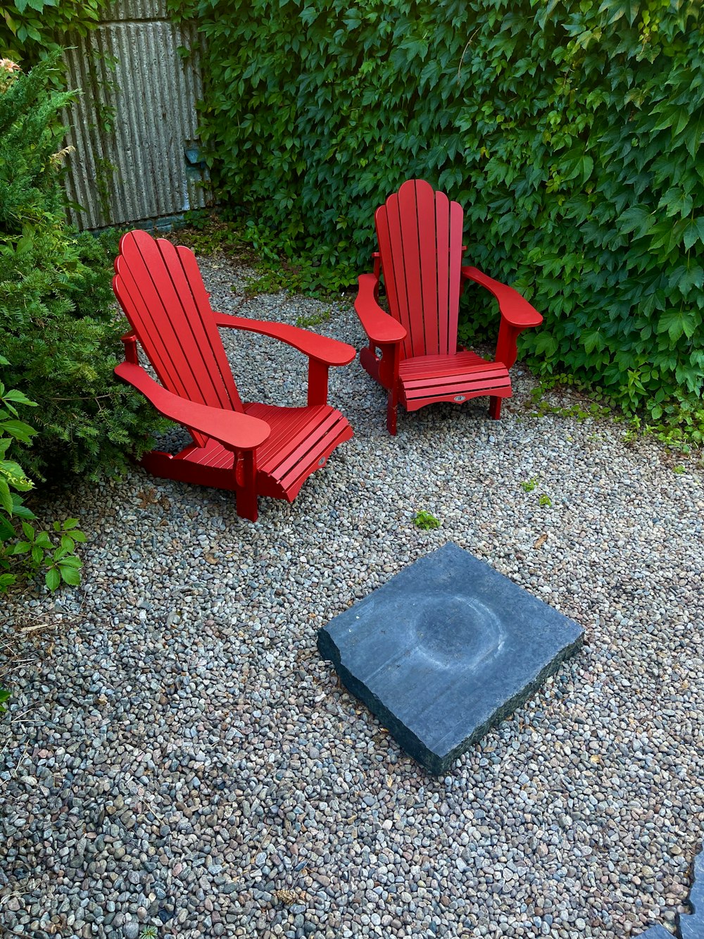 a couple of red benches sit near each other