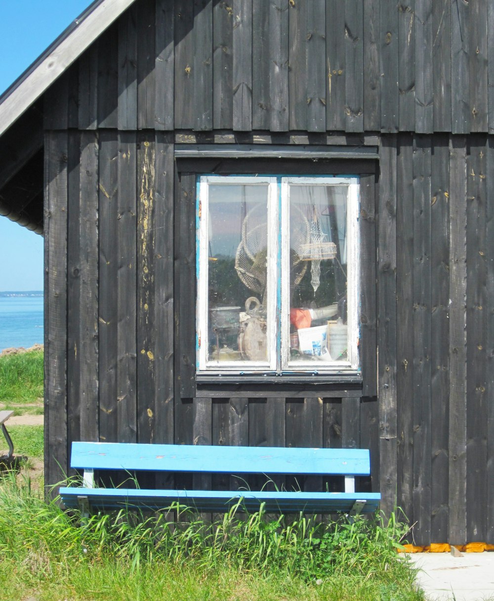 a bench in front of a wooden building