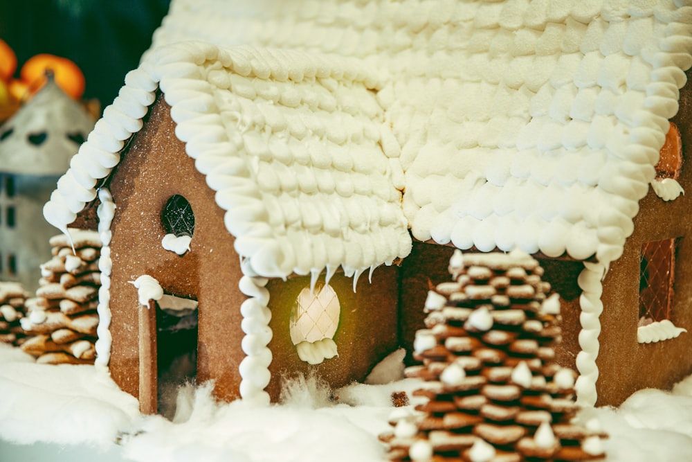 a gingerbread house with a snowman