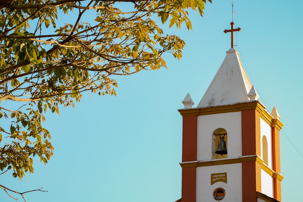 a bell tower with a cross on top