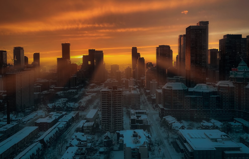 a city with buildings and a sunset