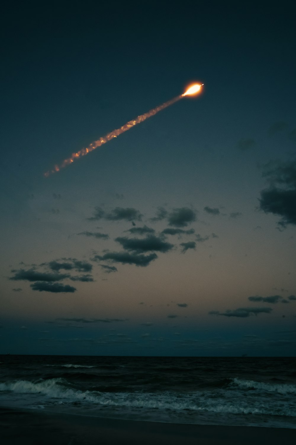a rocket flying over the ocean