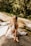 A serene landscape with a woman practicing yoga in a peaceful outdoor setting.