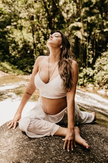a woman sitting on a rock