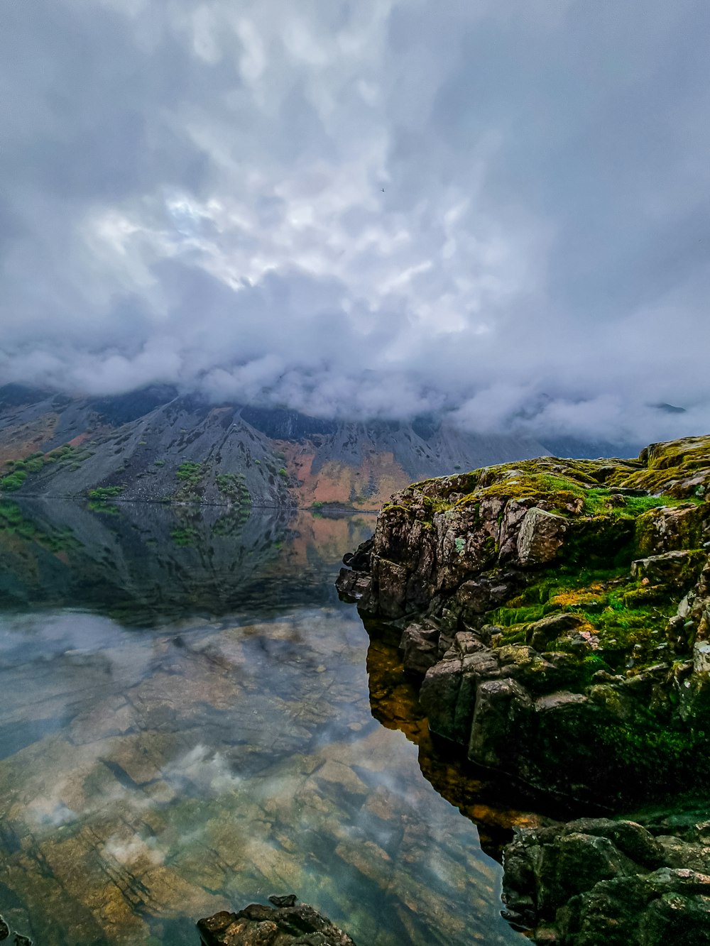 a body of water with mountains in the back