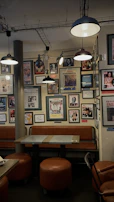 A cozy corner of the shop featuring vintage posters and a comfortable seating area.